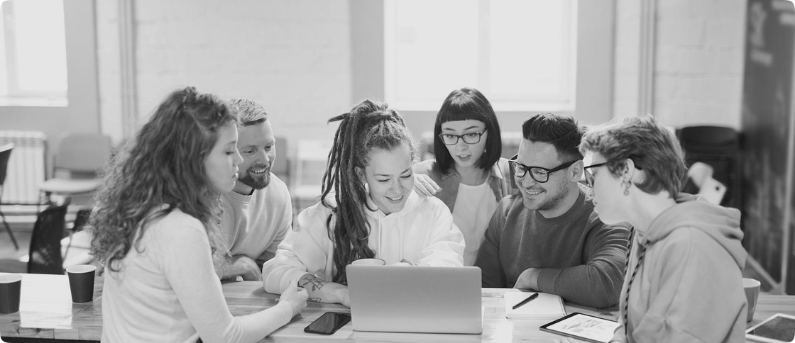 People collaborating around a laptop